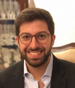 Image of a smiling man with beard and glasses.